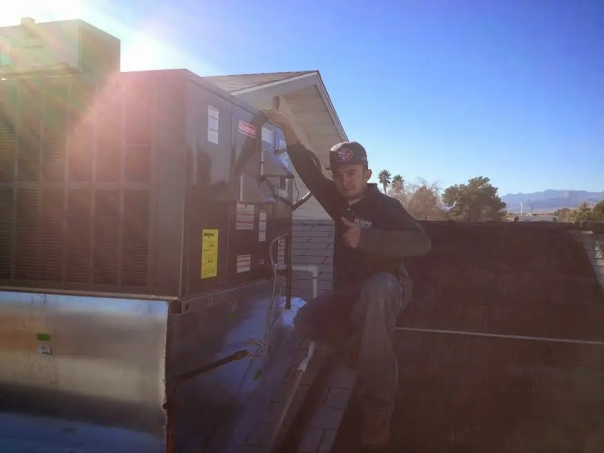 HVAC technician performing HVAC Inspection on a rooftop unit in Mount Arlington